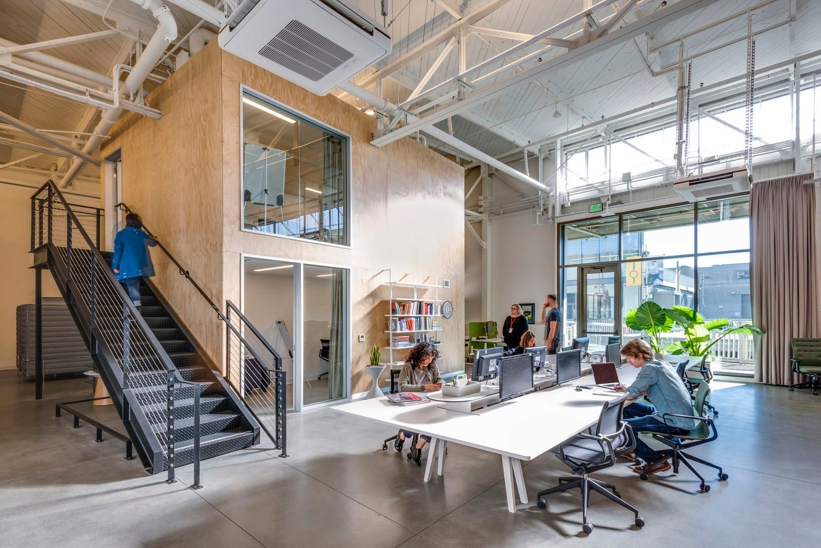 Amber office at Pier 17 in San Francisco, open workspace under industrial beams