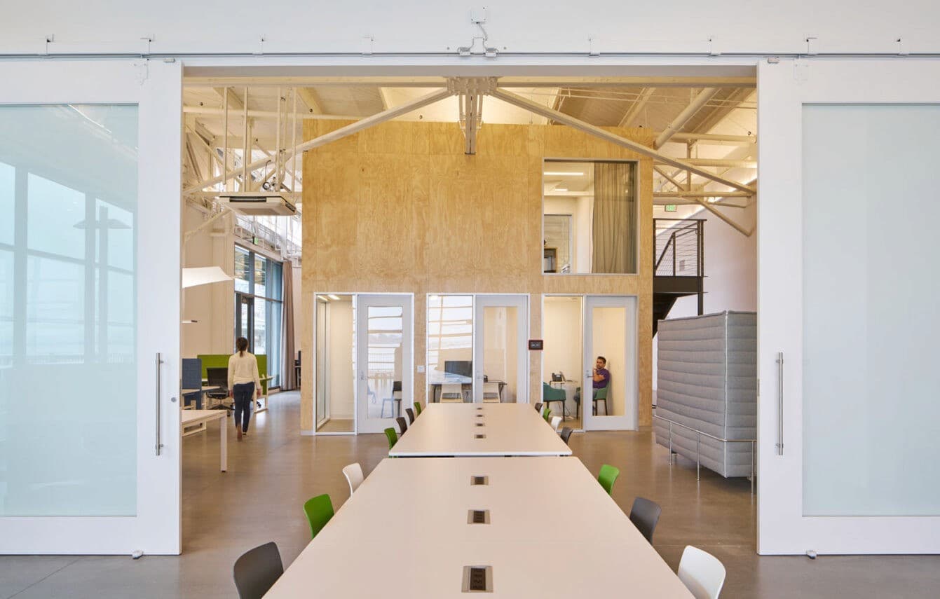 Meeting room with green chairs at Amber's Pier 17 office
